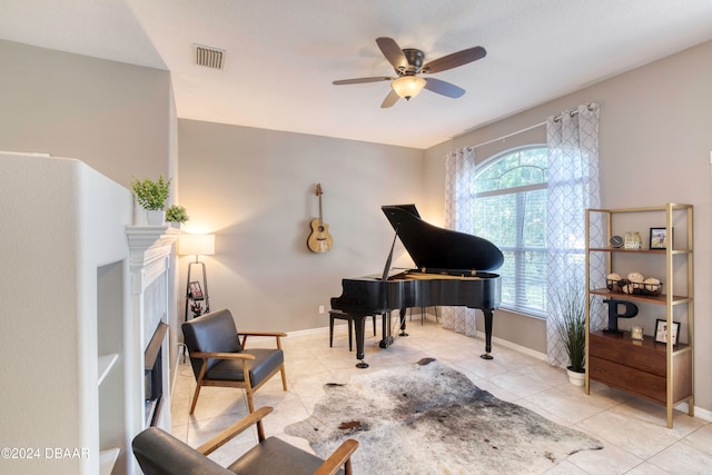 sitting room featuring light tile patterned floors and ceiling fan