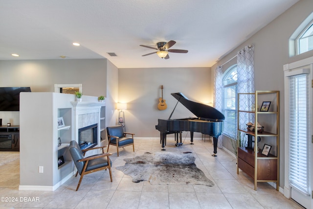 sitting room featuring ceiling fan and light tile patterned flooring