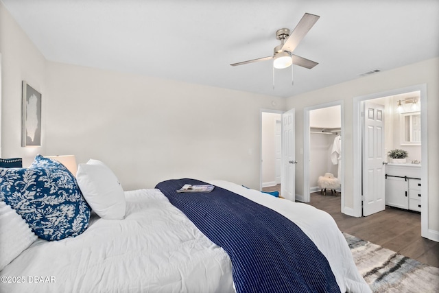 bedroom featuring visible vents, baseboards, a ceiling fan, and wood finished floors