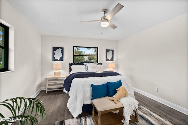 bedroom featuring wood finished floors, baseboards, and ceiling fan