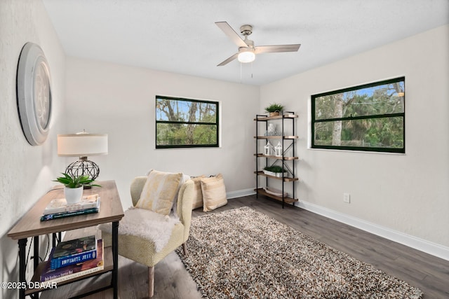 office area with baseboards, wood finished floors, and ceiling fan