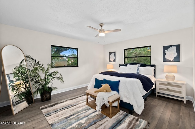 bedroom featuring baseboards, a textured ceiling, wood finished floors, and a ceiling fan