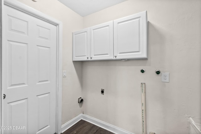 washroom with baseboards, hookup for a gas dryer, cabinet space, electric dryer hookup, and dark wood-style flooring