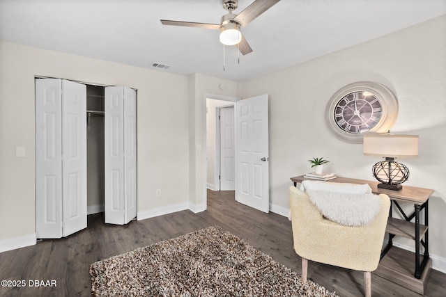 office featuring wood finished floors, a ceiling fan, visible vents, and baseboards