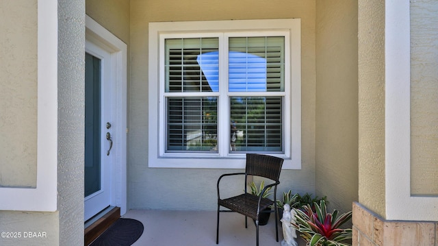 doorway to property with stucco siding