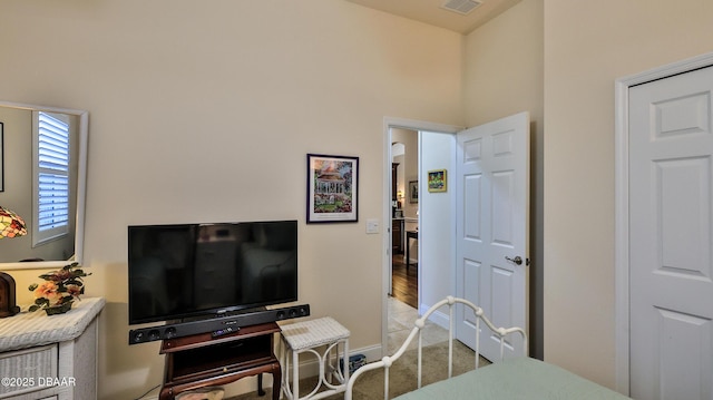 bedroom with carpet floors, baseboards, and visible vents