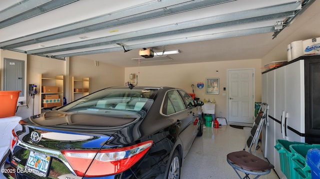 garage featuring a garage door opener and electric panel