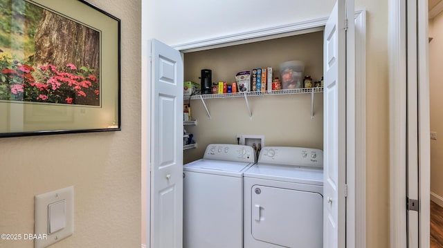 laundry area featuring laundry area, washer and clothes dryer, and wood finished floors