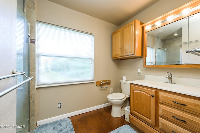 full bathroom featuring baseboards, toilet, wood finished floors, an enclosed shower, and vanity