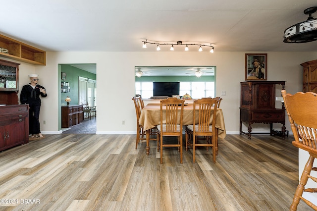 dining space with light wood-type flooring, ceiling fan, and baseboards