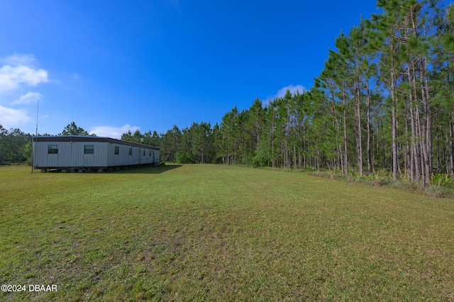 view of yard with a forest view