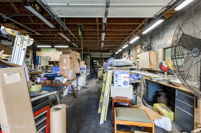 miscellaneous room featuring concrete block wall and a workshop area