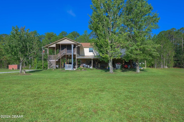 view of front of property featuring a front yard and stairs