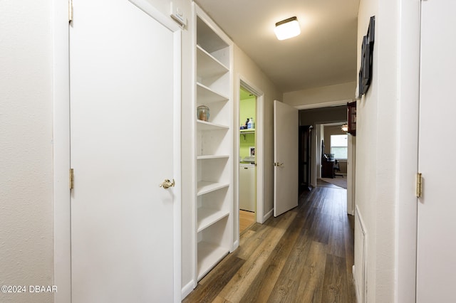 hall featuring dark wood-type flooring and baseboards