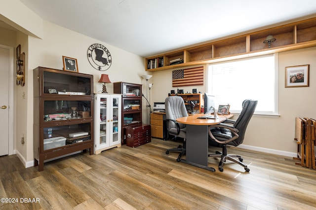 office area with baseboards and wood finished floors