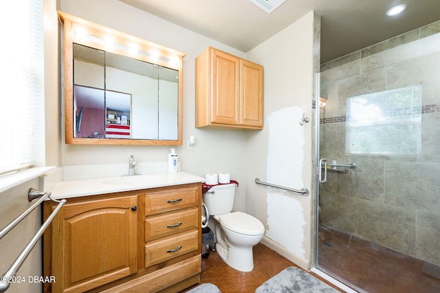 full bathroom featuring visible vents, vanity, a shower stall, and toilet