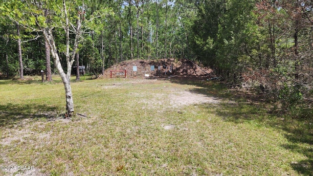 view of yard with a view of trees