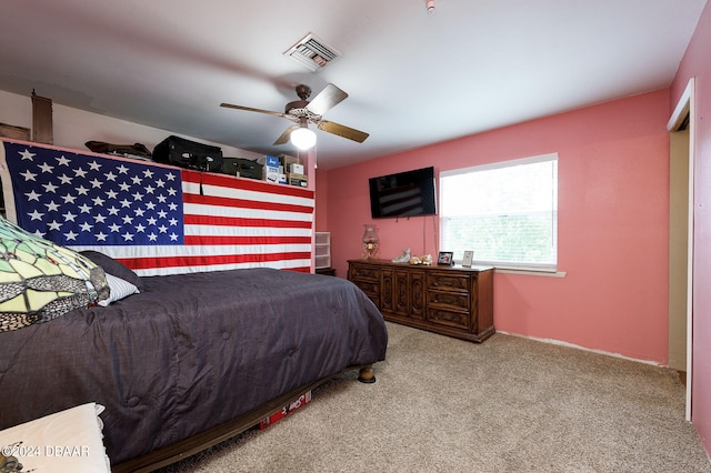 bedroom with carpet floors, visible vents, and a ceiling fan