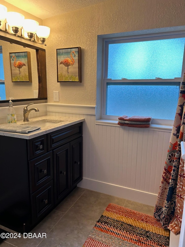 bathroom featuring tile patterned flooring and vanity