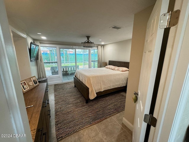 bedroom featuring access to exterior and light tile patterned floors