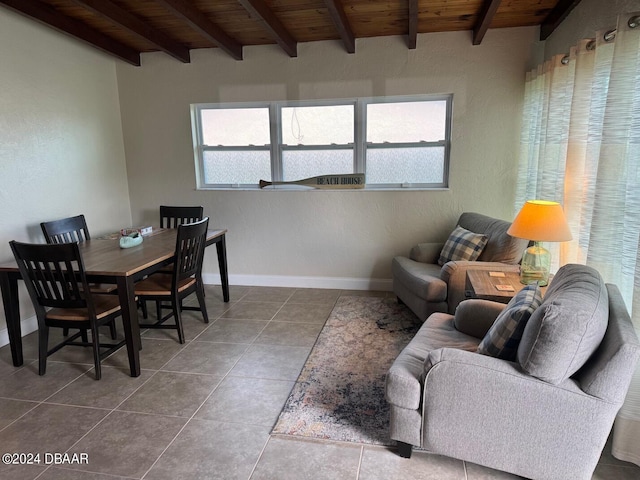 dining space with beam ceiling, tile patterned floors, and wood ceiling