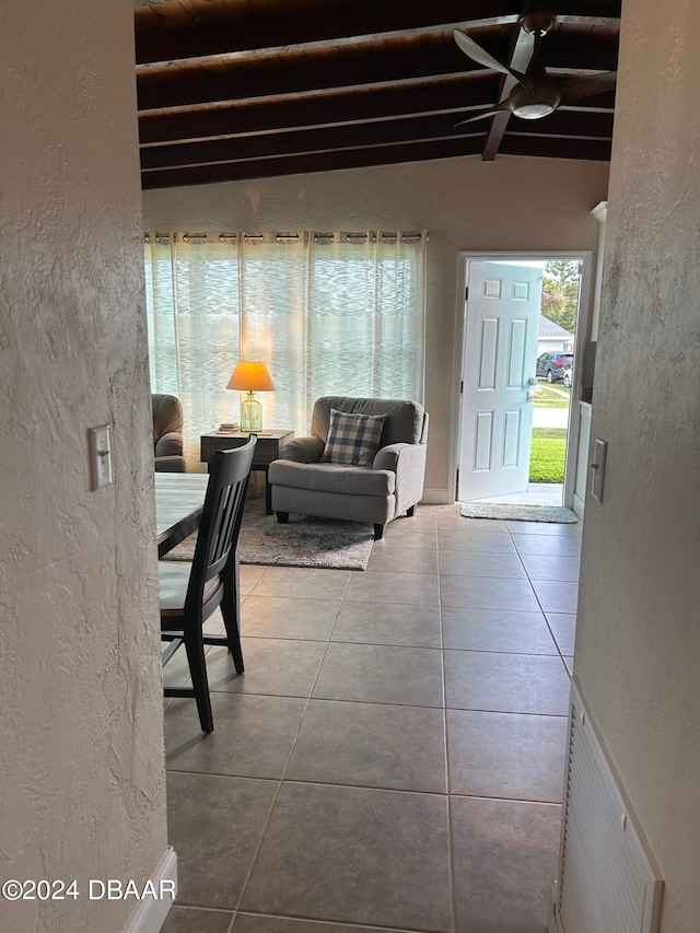 tiled entryway featuring beamed ceiling and ceiling fan