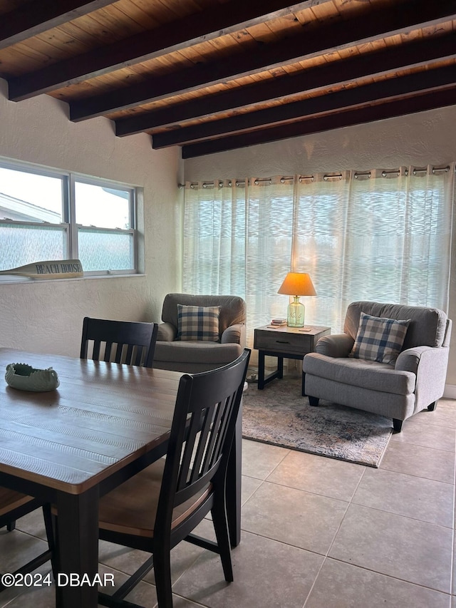 dining room with beam ceiling, wooden ceiling, and light tile patterned floors