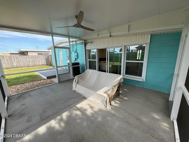 unfurnished sunroom with ceiling fan and vaulted ceiling