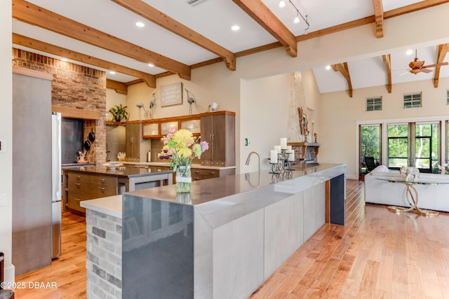 3 Ashford Lakes Dr, Ormond Beach, FL 32174 - kitchen with beam ceiling, light wood-style flooring, a large island, recessed lighting, and freestanding refrigerator