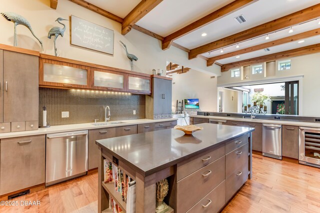 3 Ashford Lakes Dr, Ormond Beach, FL 32174 - kitchen with a sink, stainless steel dishwasher, wine cooler, decorative backsplash, and a kitchen island