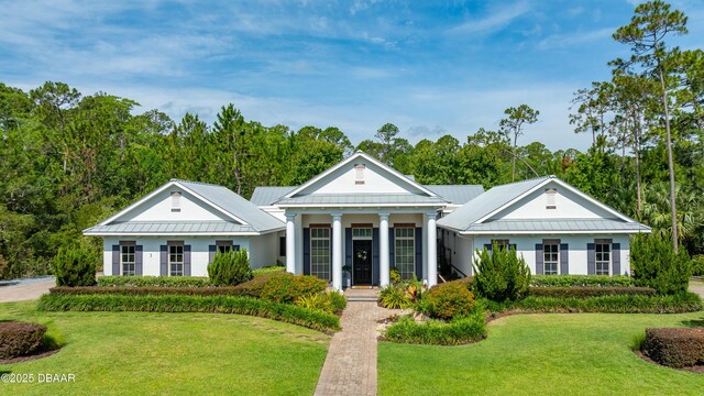 3 Ashford Lakes Dr, Ormond Beach, FL 32174 - view of front of house featuring a front lawn, stucco siding, and metal roof