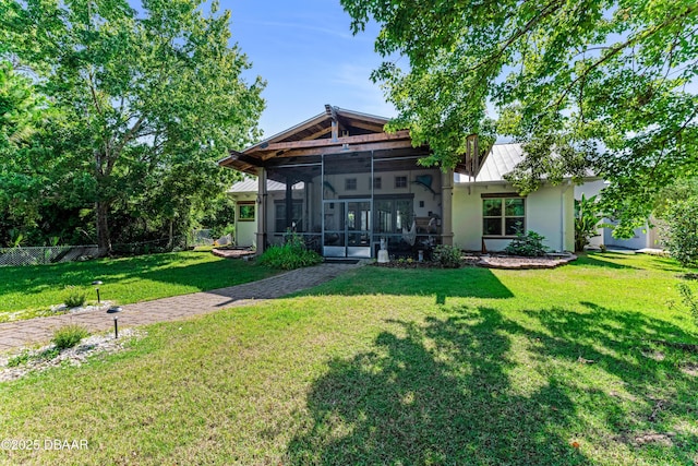 3 Ashford Lakes Dr, Ormond Beach, FL 32174 - back of property featuring stucco siding, a sunroom, a standing seam roof, and metal roof