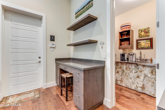 3 Ashford Lakes Dr, Ormond Beach, FL 32174 - home office with light wood-type flooring, baseboards, and a sink
