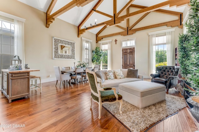 3 Ashford Lakes Dr, Ormond Beach, FL 32174 - living room featuring light wood-style floors, beam ceiling, baseboards, and high vaulted ceiling