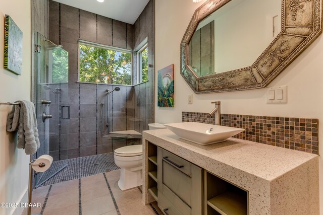 3 Ashford Lakes Dr, Ormond Beach, FL 32174 - full bath featuring toilet, backsplash, a shower stall, vanity, and tile patterned flooring
