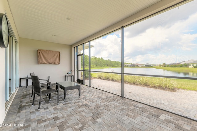 sunroom / solarium with a water view