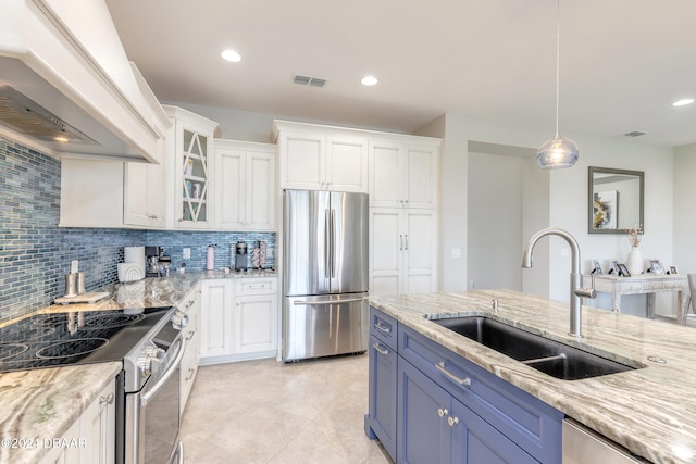 kitchen featuring stainless steel appliances, blue cabinets, sink, white cabinetry, and premium range hood