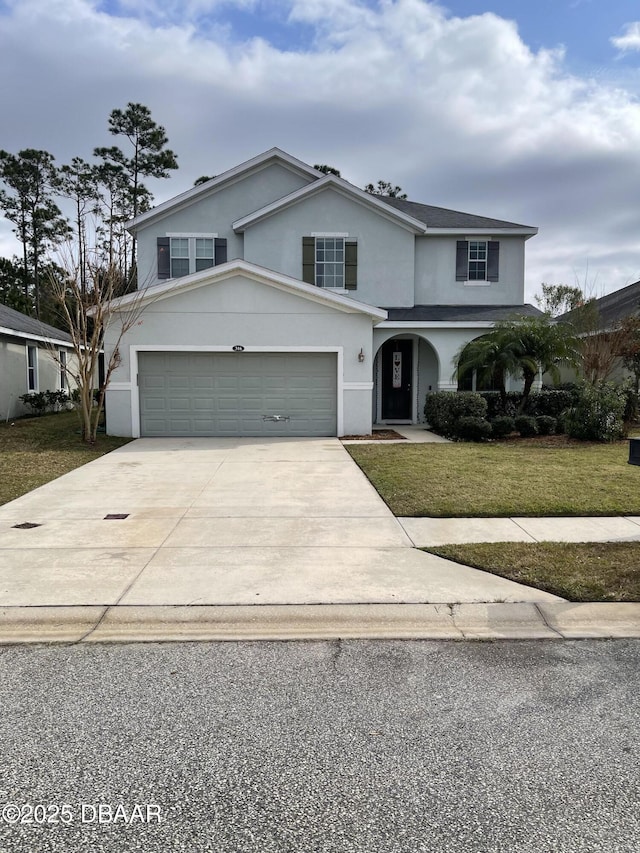 front of property featuring a garage and a front lawn