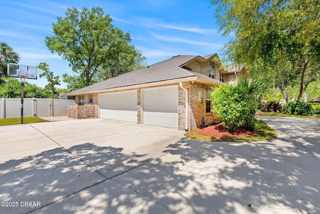 6 Leisure Wood Way, Ormond Beach, FL 32174 - view of side of home with a gate, driveway, brick siding, an attached garage, and fence