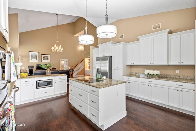 6 Leisure Wood Way, Ormond Beach, FL 32174 - kitchen with appliances with stainless steel finishes, visible vents, high vaulted ceiling, and dark wood-style floors