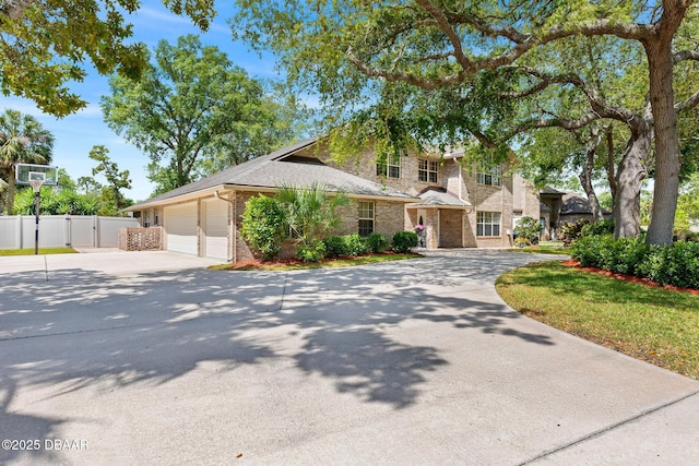 6 Leisure Wood Way, Ormond Beach, FL 32174 - view of front facade featuring a gate, brick siding, fence, driveway, and an attached garage