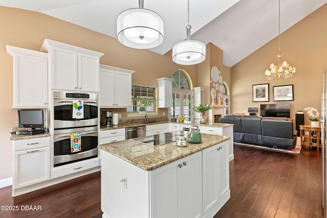 6 Leisure Wood Way, Ormond Beach, FL 32174 - kitchen featuring a sink, appliances with stainless steel finishes, a center island, dark wood-type flooring, and high vaulted ceiling