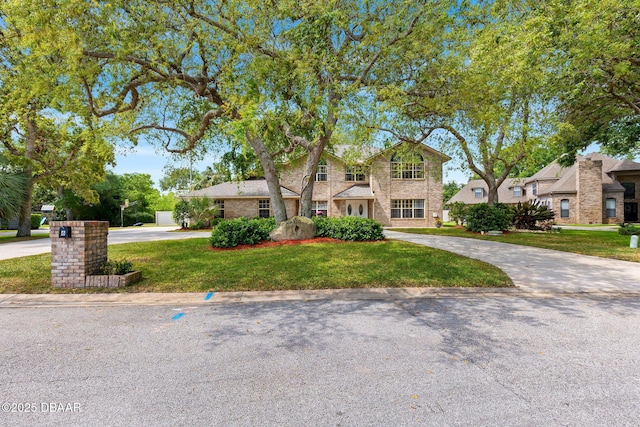 6 Leisure Wood Way, Ormond Beach, FL 32174 - traditional-style home with a front yard and curved driveway