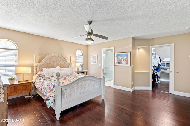 6 Leisure Wood Way, Ormond Beach, FL 32174 - bedroom with a textured ceiling, a spacious closet, dark wood-style floors, and baseboards