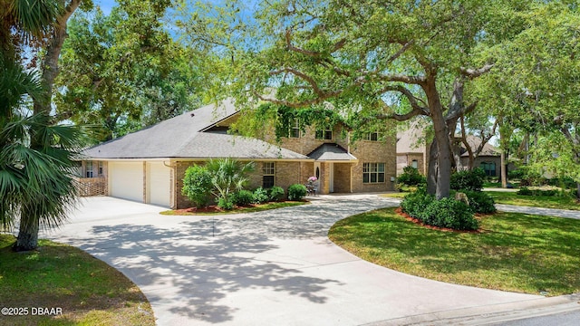 6 Leisure Wood Way, Ormond Beach, FL 32174 - view of front of house featuring a garage, brick siding, and curved driveway