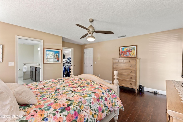 6 Leisure Wood Way, Ormond Beach, FL 32174 - bedroom with visible vents, dark wood-style flooring, a ceiling fan, ensuite bath, and a walk in closet