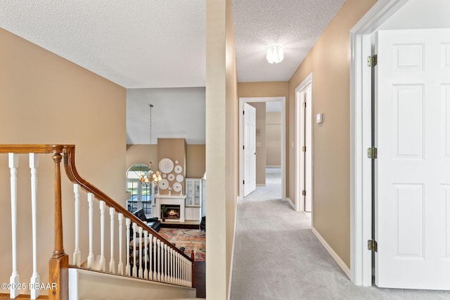 6 Leisure Wood Way, Ormond Beach, FL 32174 - corridor featuring stairs, a textured ceiling, carpet floors, and baseboards