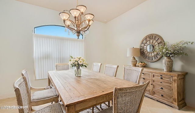 dining area with an inviting chandelier, light tile patterned floors, and baseboards