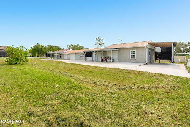 back of house featuring a yard, metal roof, and fence