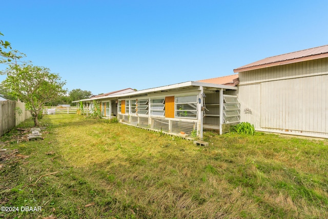 view of yard featuring an outbuilding and fence